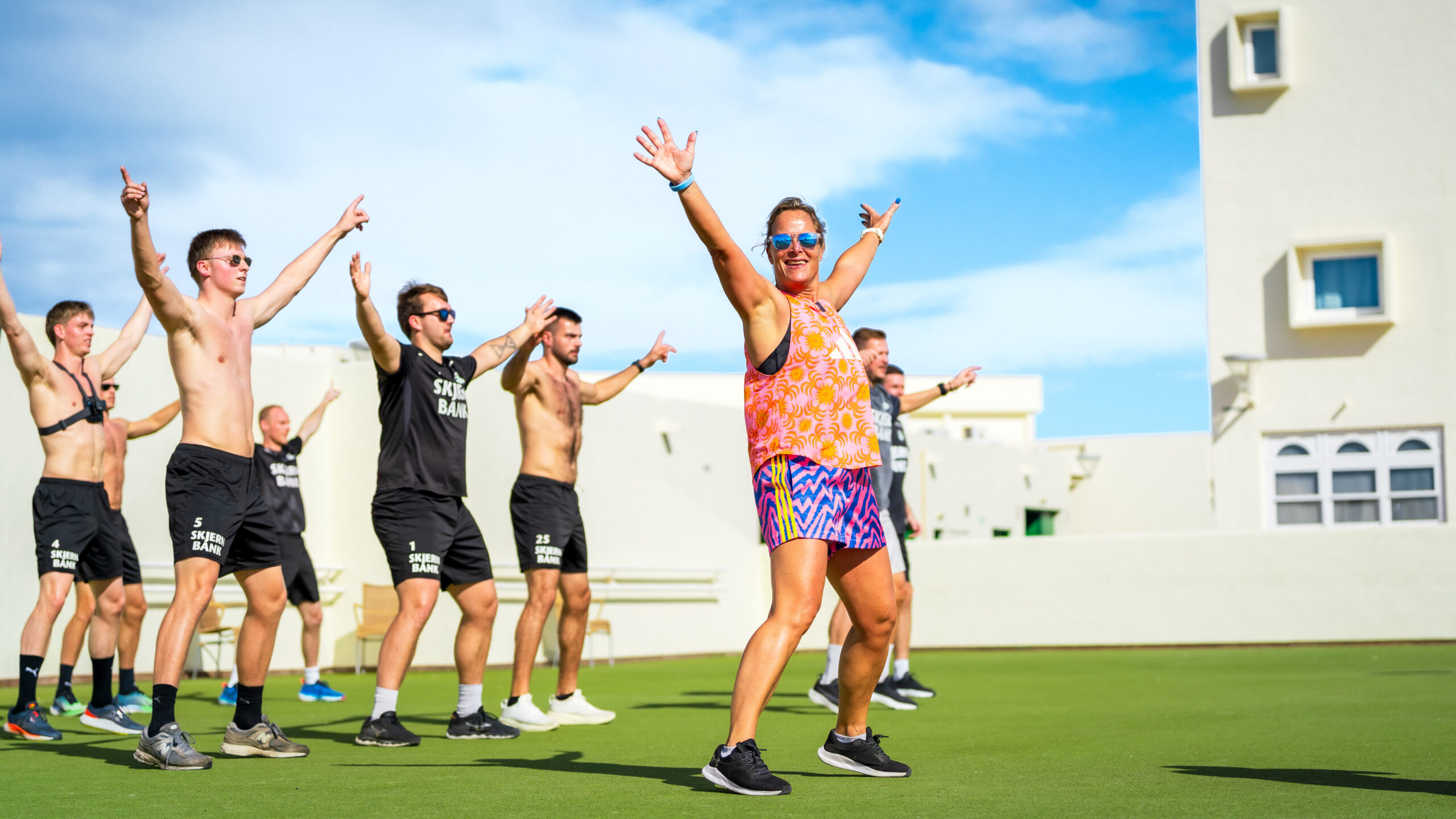 A group of men copying the female instructor in a Zumba class at Club La Santa.