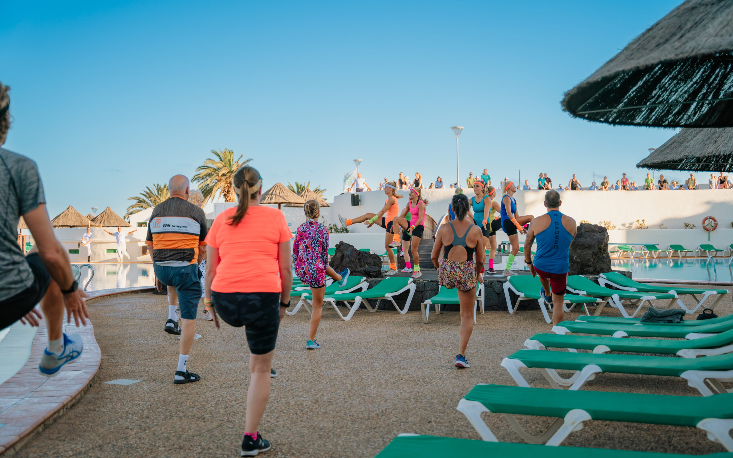 A group by the pool taking part in the morning gymnastics at Club La Santa