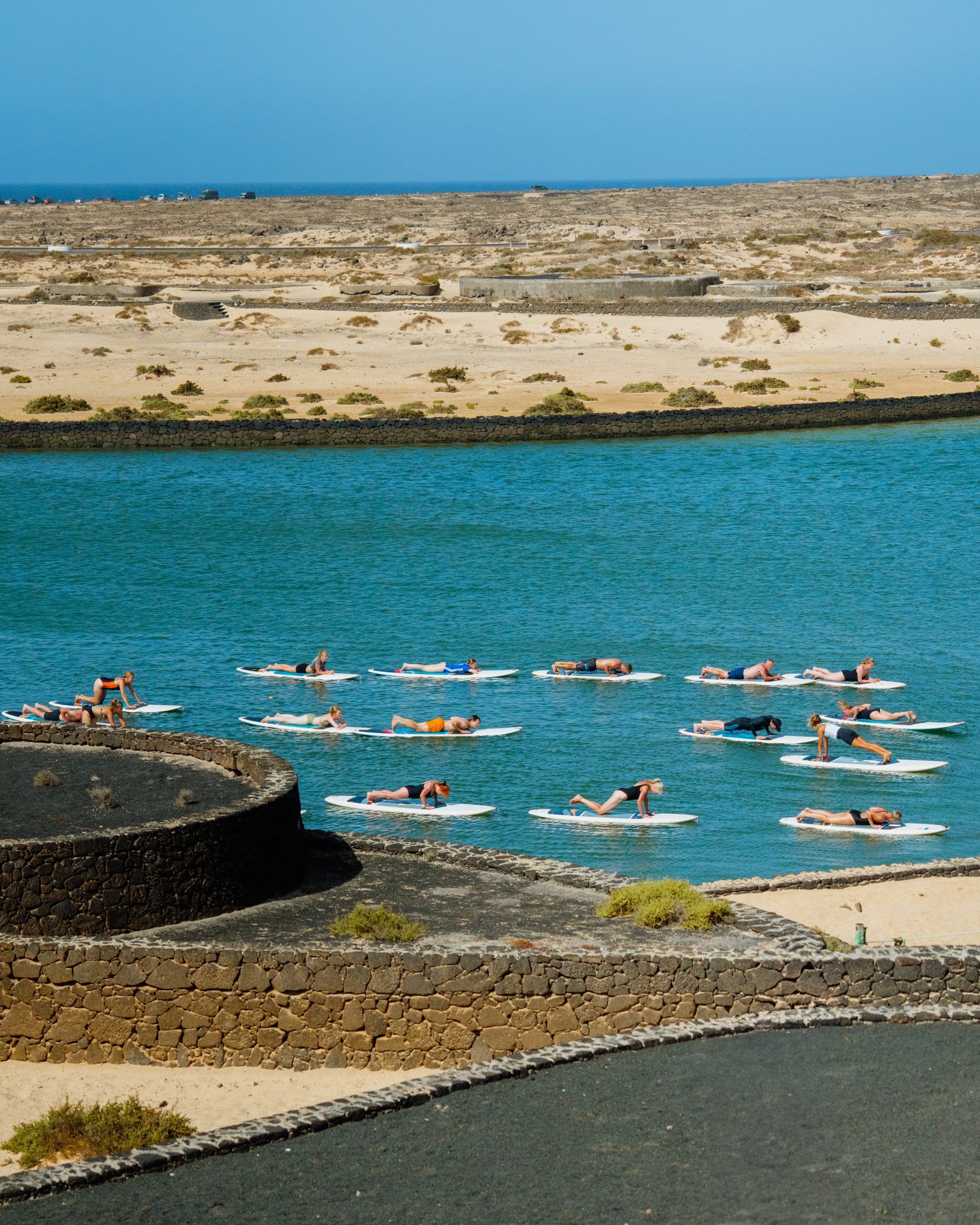 A group taking part in a stand up paddle board class at Club La Santa