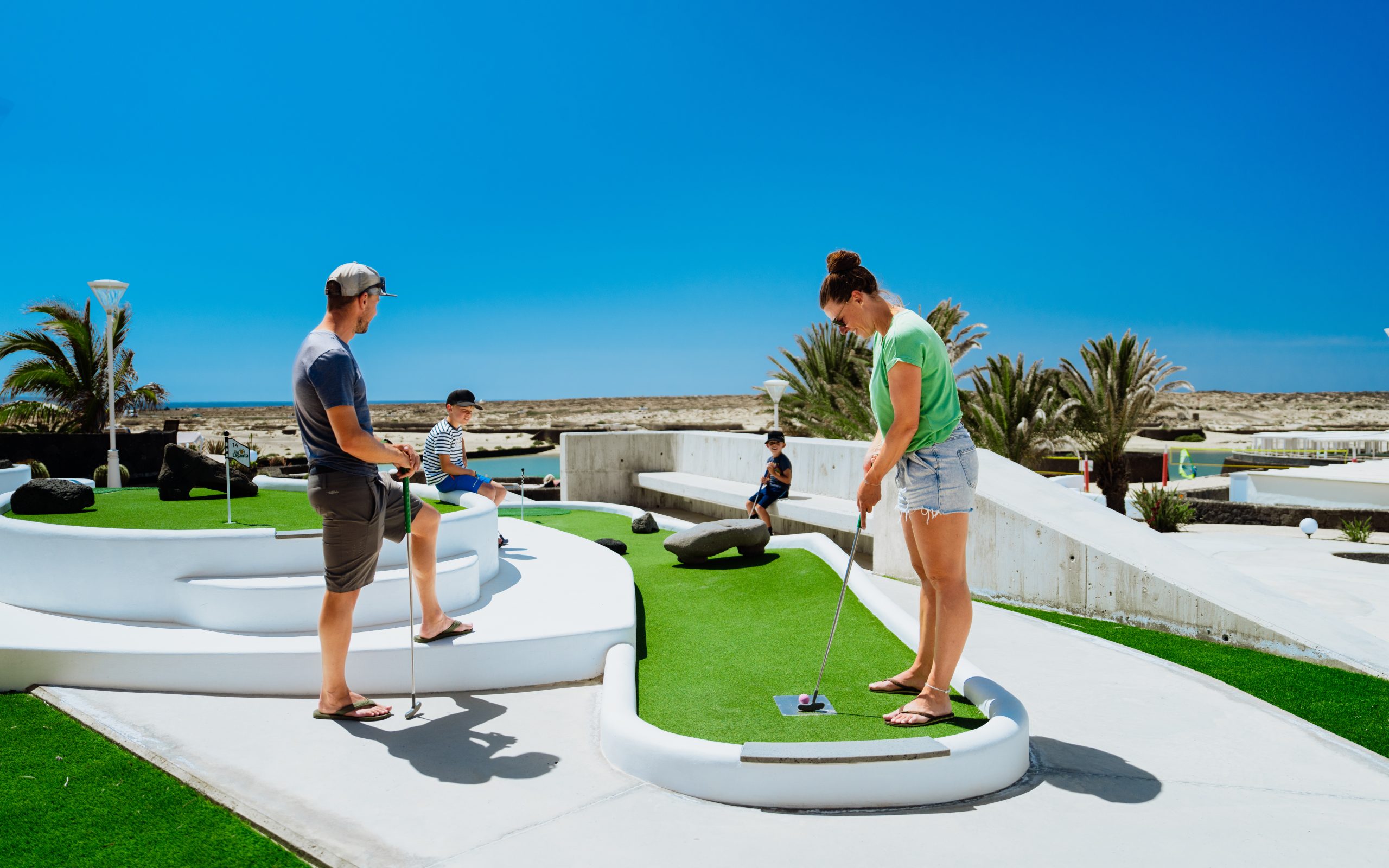 A family having fun playing mini golf at Club La Santa