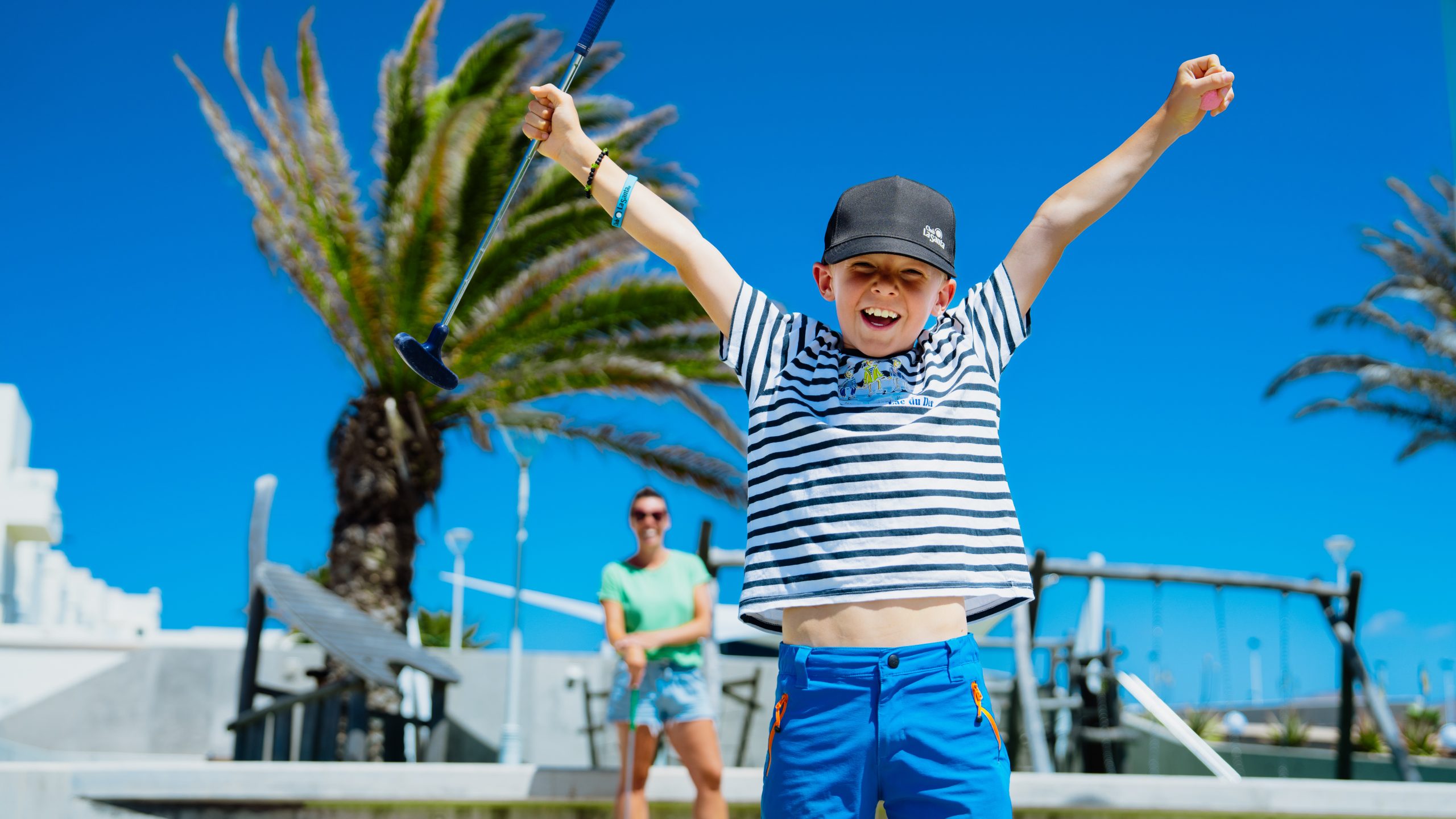 A boy celebrating after a fun golf activity at Club La Santa