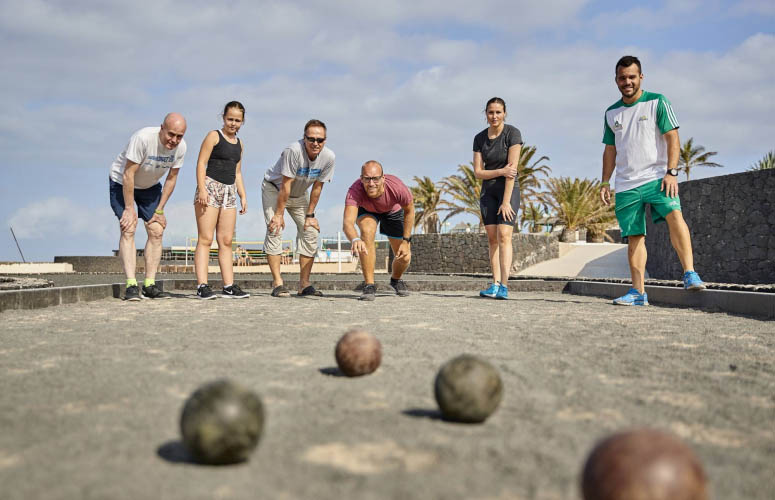 A group of people playing Pétanque at Club La Santa