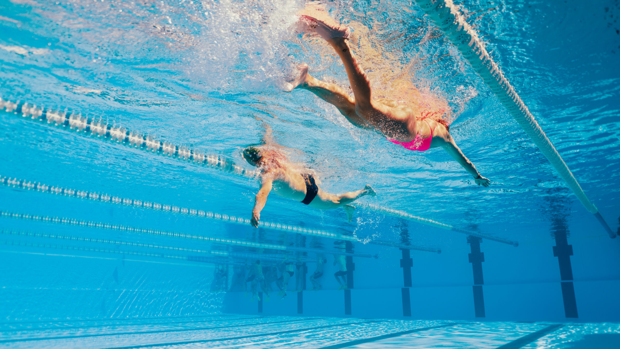 A man and lady swimming in the olympic style swimming pools at Club La Santa