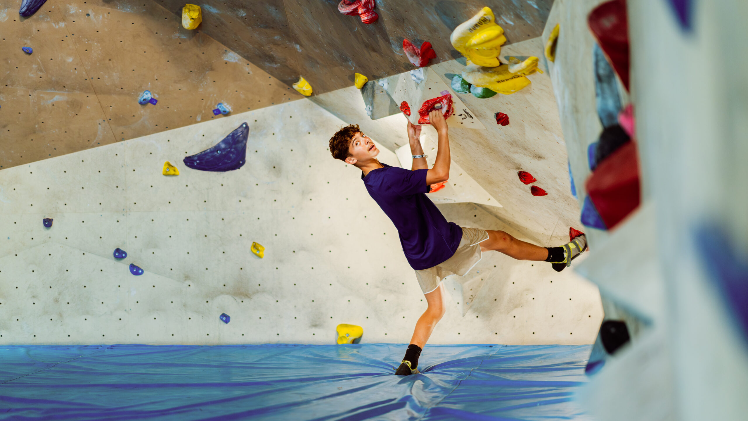 A boy climbing in the bouldering centre at Club La Santa.