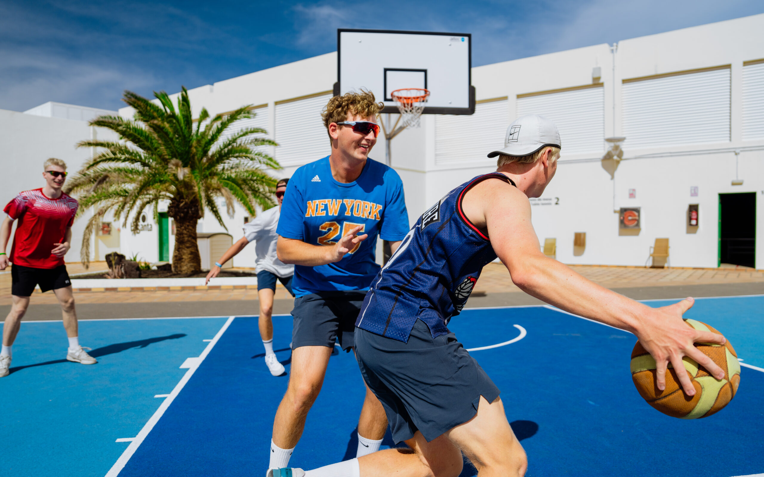 Men playing basketball on the court at Club La Santa.