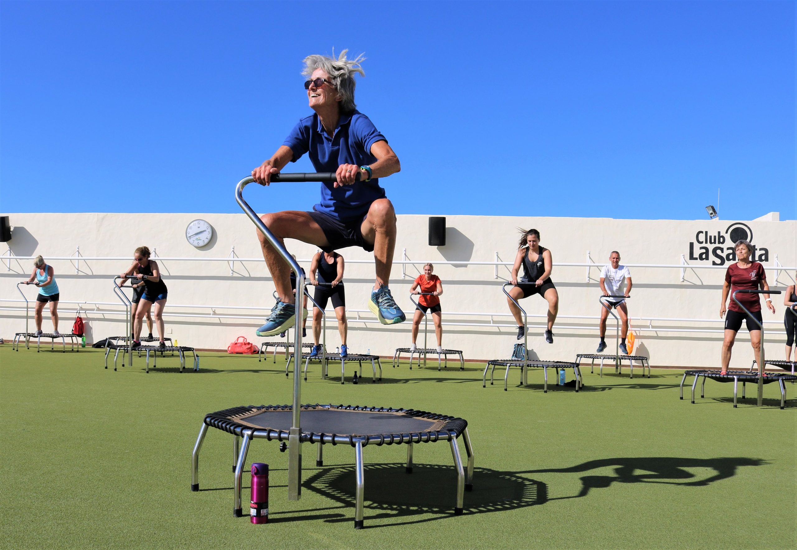 A group bouncing on mini trampolines in a trampoline fitness class at Club La Santa