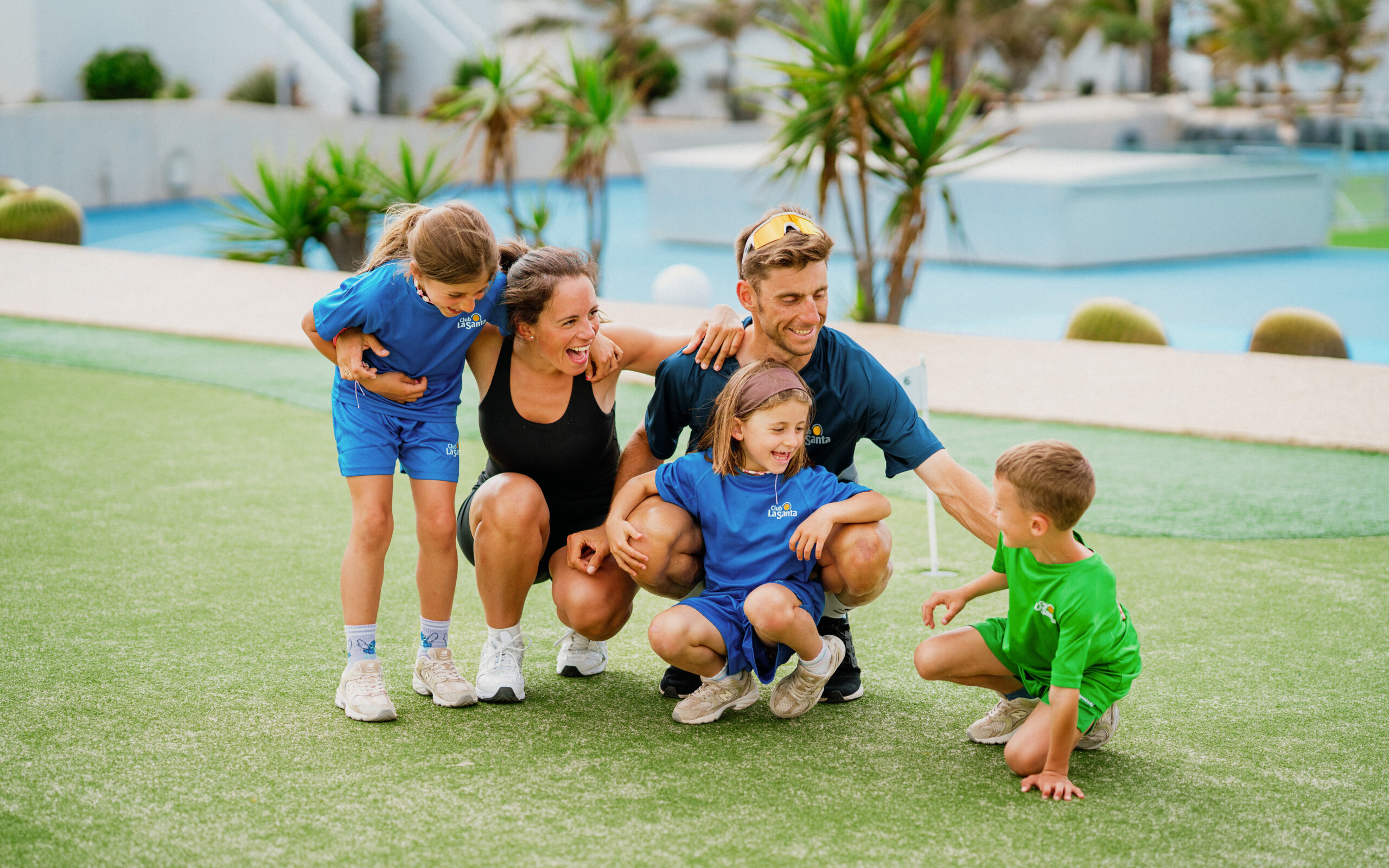 A family crouched on the grass at Club La Santa.