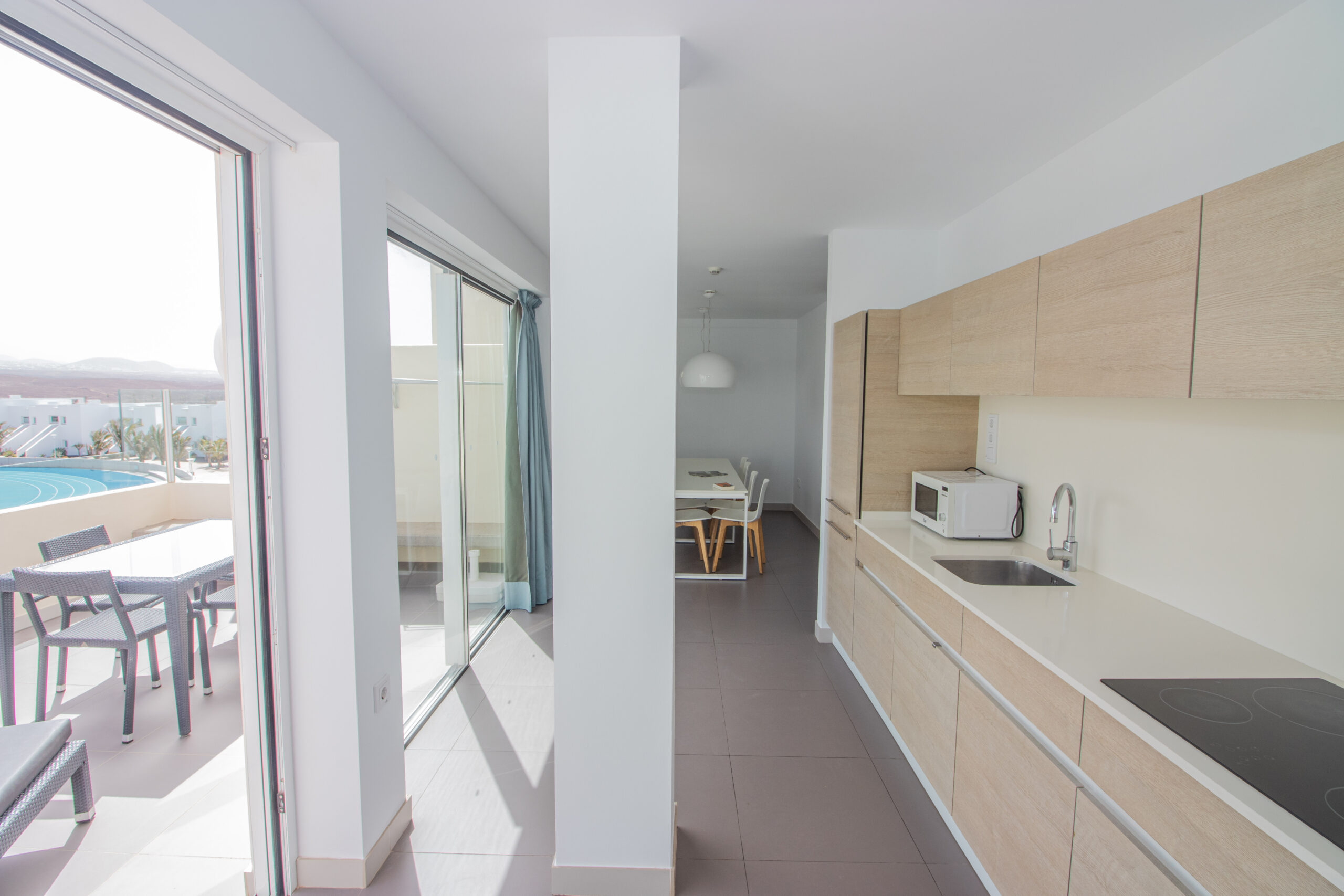 The Terrace + Kitchen of the comfort 2 bedroom 2 bathroom apartment with a view at Club La Santa.