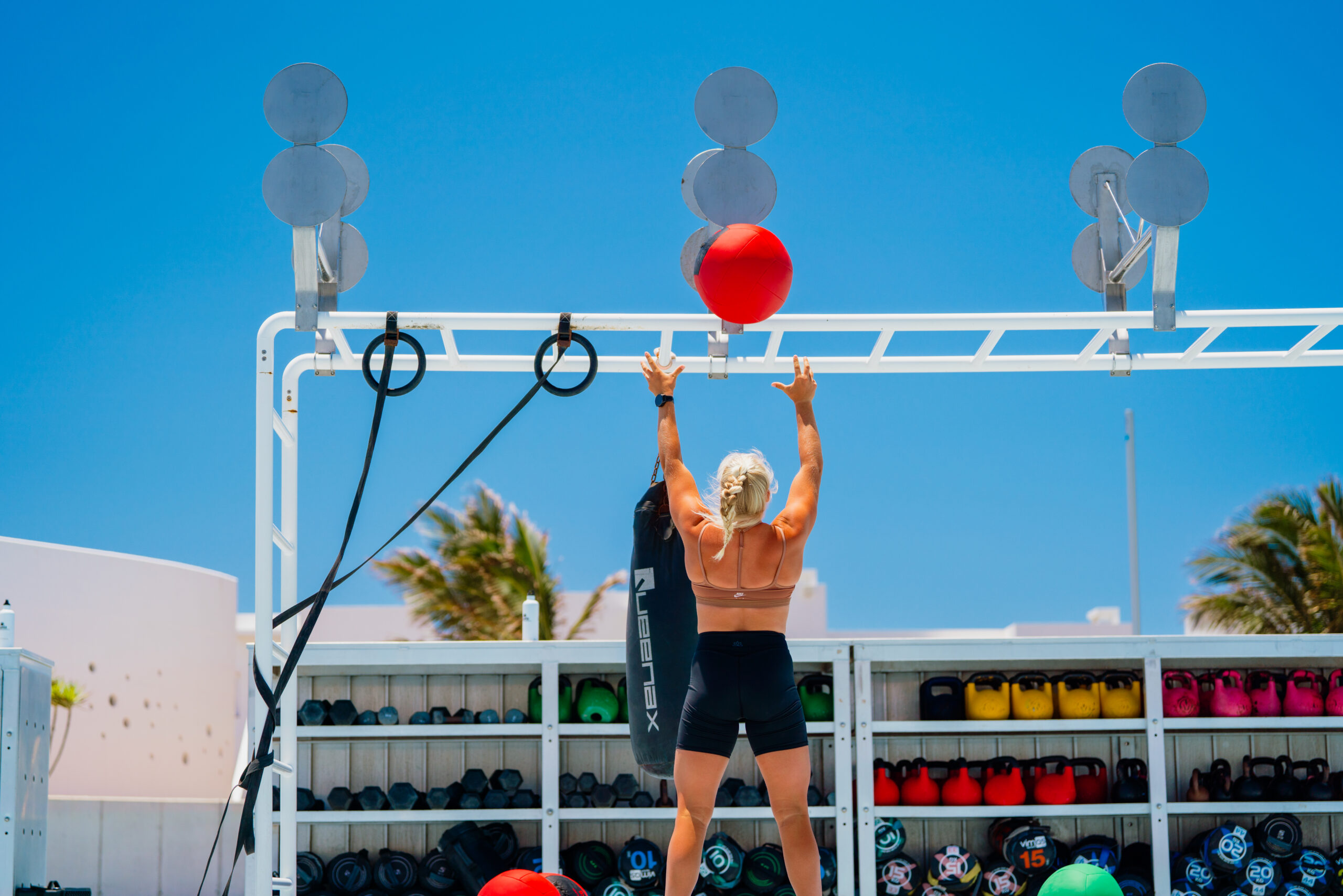 A woman doing 'wall balls' in the outdoor functional training area at Club La Santa