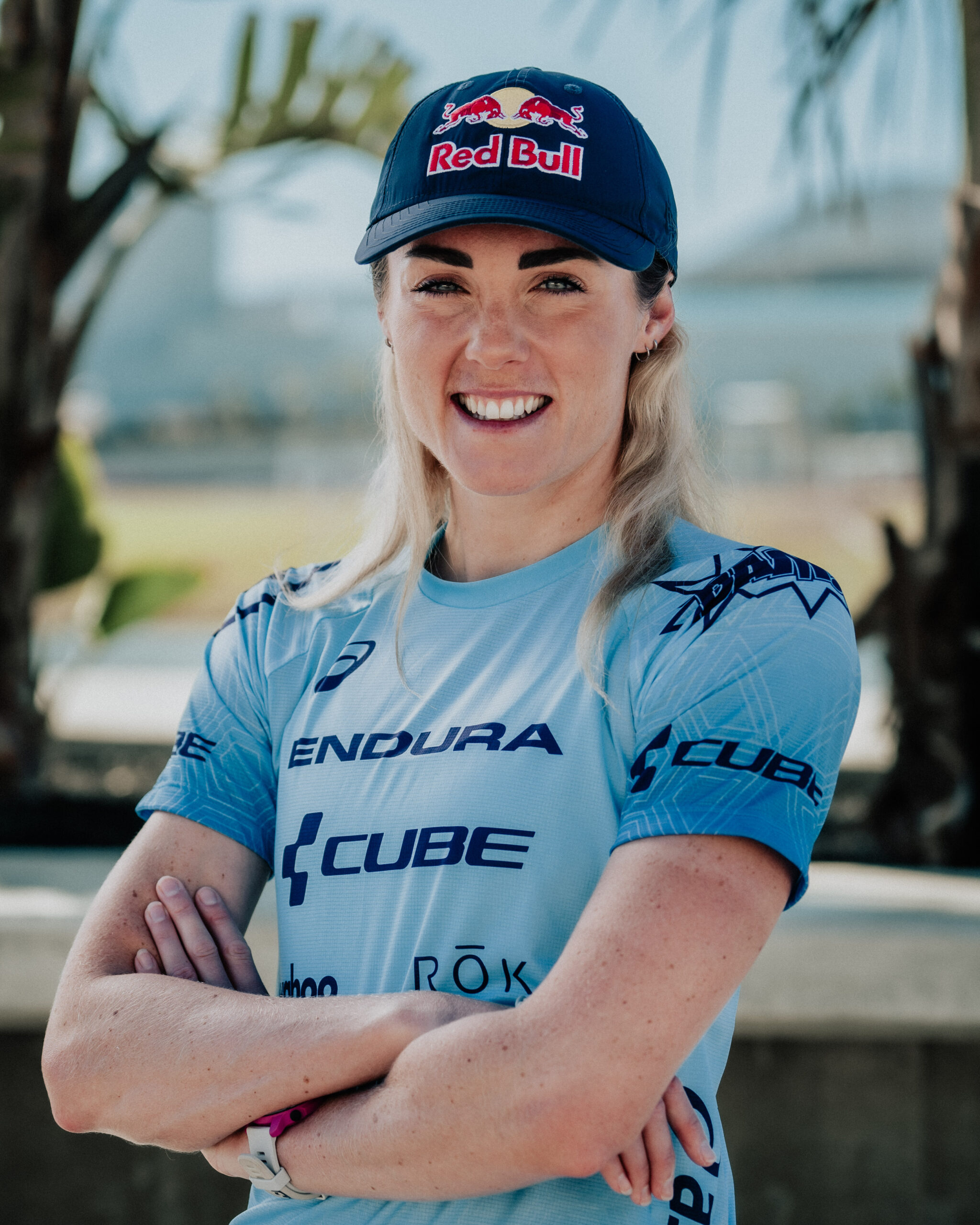 A headshot image of Lucy Charles-Barclay, wearing a blue cycling top and navy Red Bull branded cap.