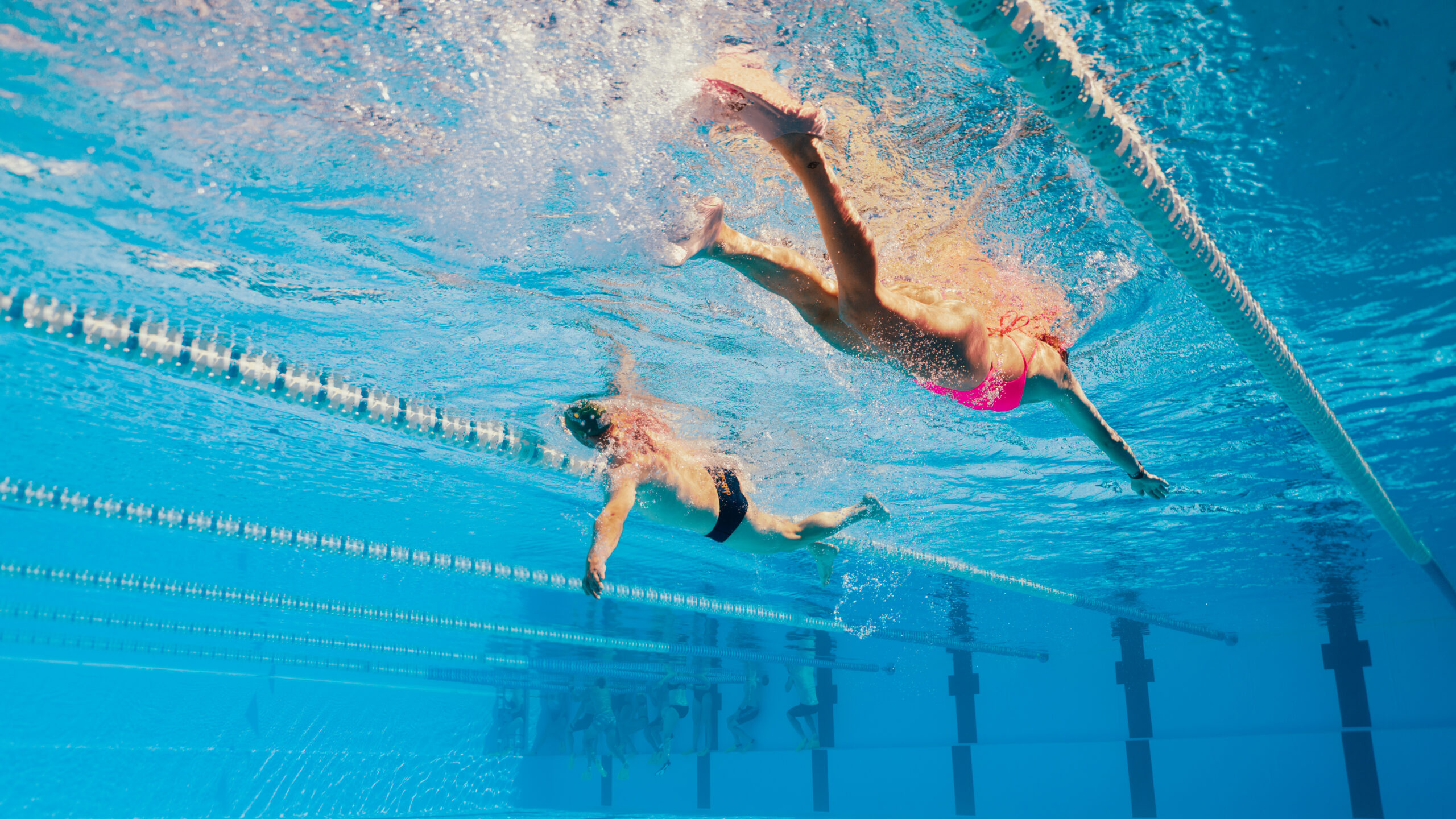 A photo taken from underwater of two swimmers in the 50m pool