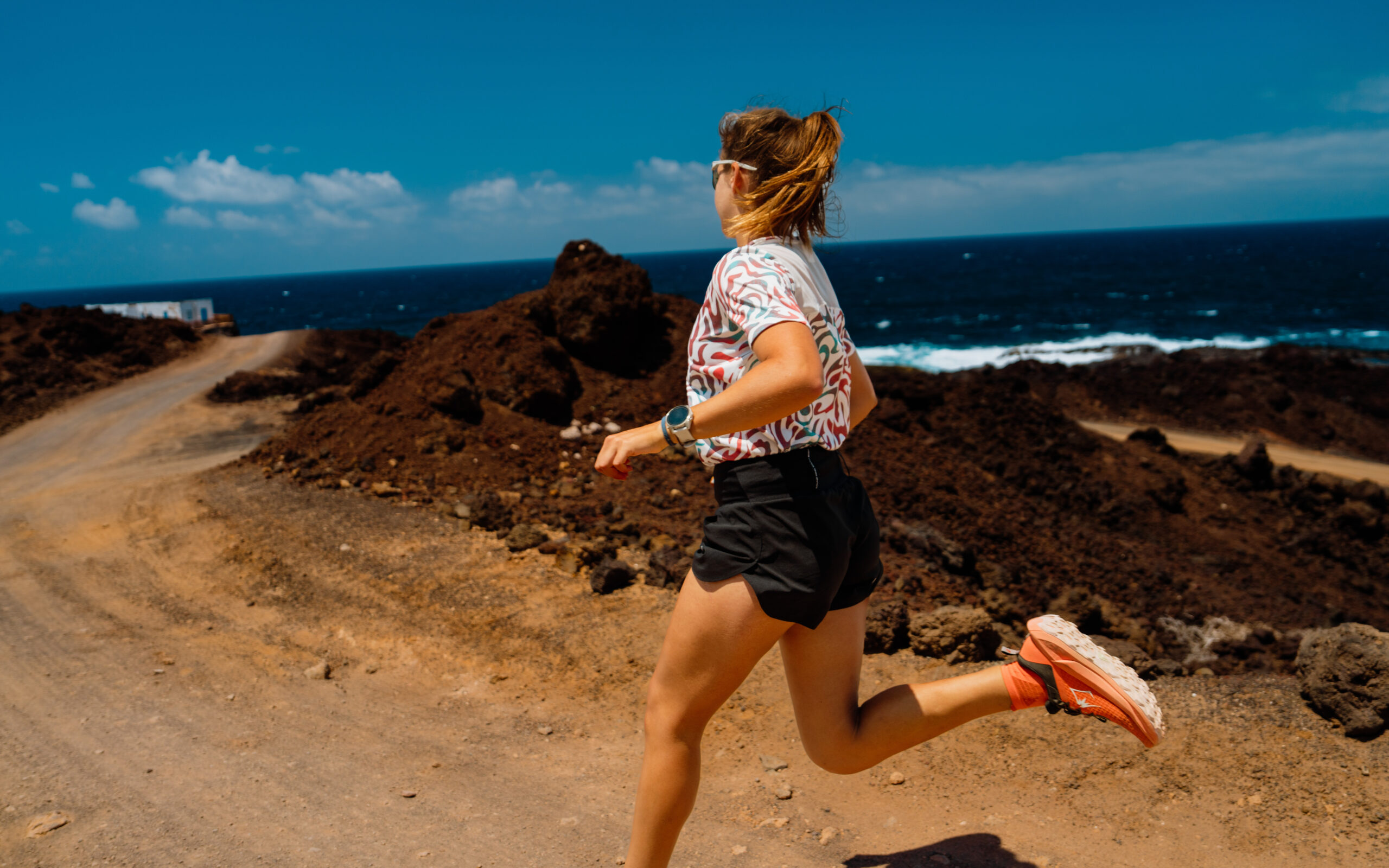 A woman running by the sea in Lanzarote.